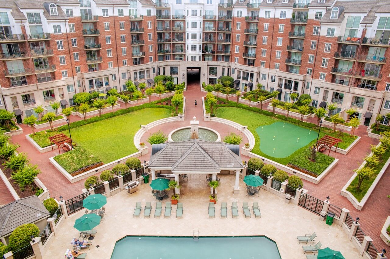 A view of an outdoor pool and patio area.