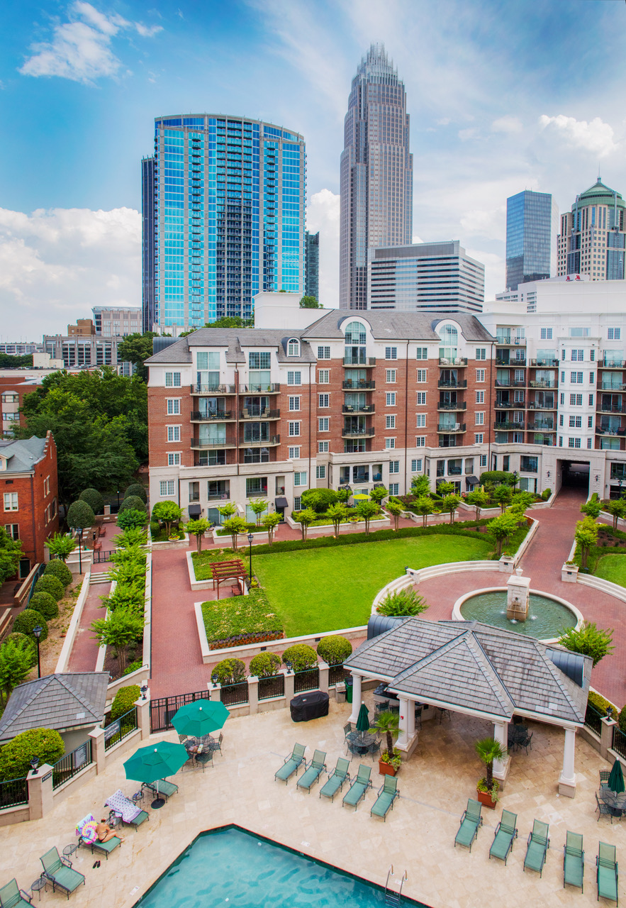 A view of the city from above shows a park and buildings.